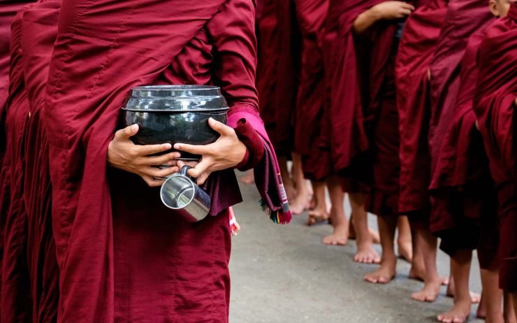 detail-of-buddhist-monks-crowd-and-person-holding-PKCY67V.jpg